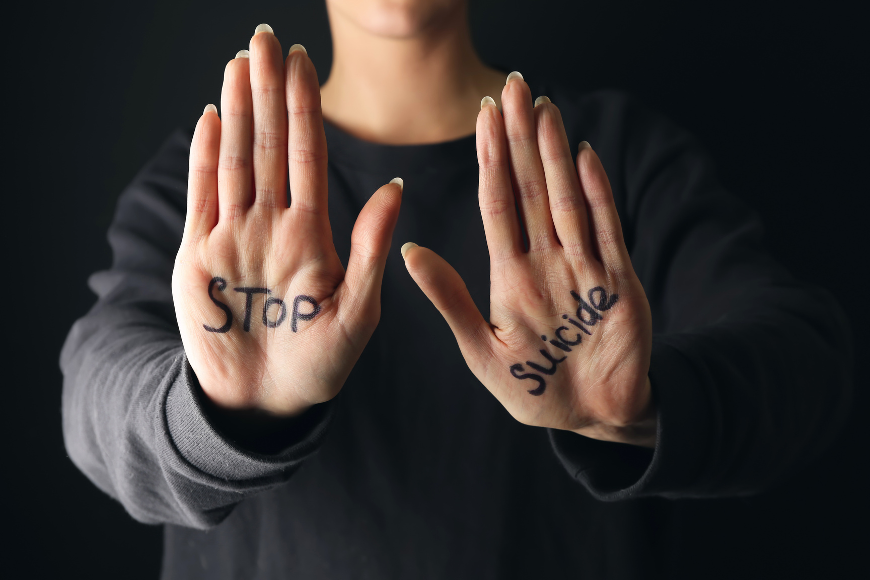 Stop Suicide Written on a Person's Palms